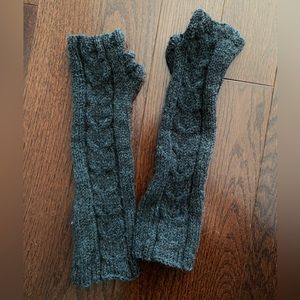 Long dark gray heather knitted fingerless gloves with thumb port.